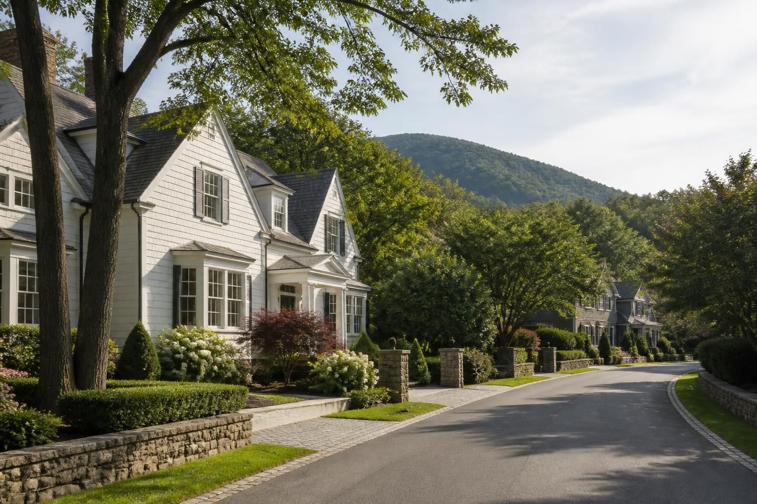 Upscale neighborhood street with landscaped properties and quiet homes.